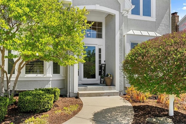 property entrance with stucco siding
