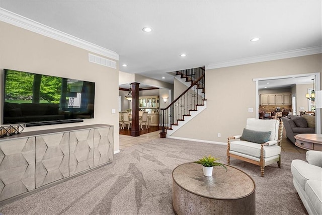 carpeted living room with decorative columns, visible vents, recessed lighting, and crown molding