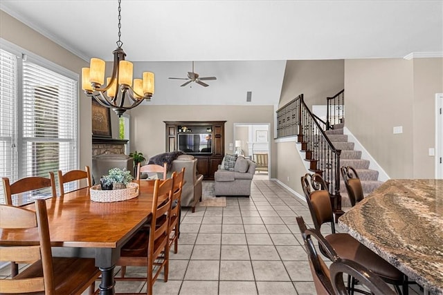 dining area with light tile patterned flooring, crown molding, baseboards, stairs, and ceiling fan with notable chandelier