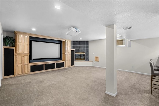 home theater with light colored carpet, baseboards, and visible vents