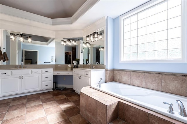 full bath with a tray ceiling, a chandelier, crown molding, a garden tub, and vanity