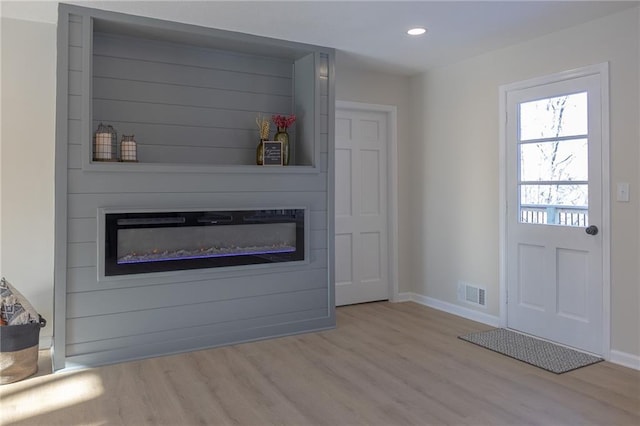 909 Bell Dr, Excelsior Springs, MO 64024 - unfurnished living room with a large fireplace, wood finished floors, baseboards, and recessed lighting