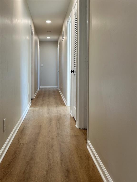 909 Bell Dr, Excelsior Springs, MO 64024 - corridor featuring wood finished floors, baseboards, and recessed lighting