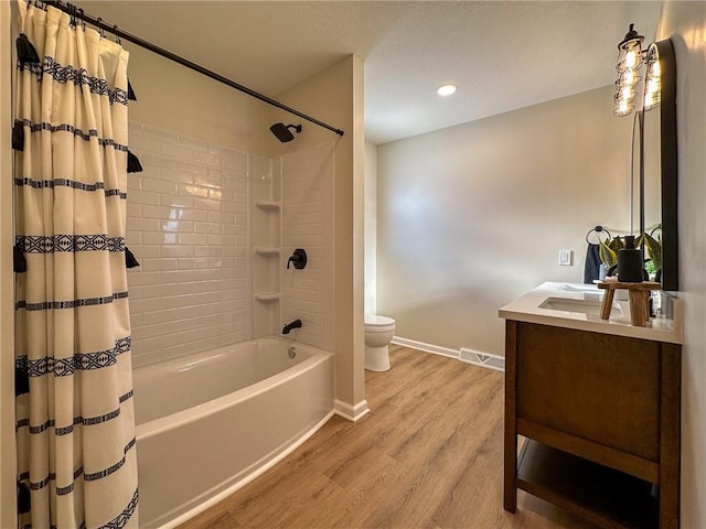 909 Bell Dr, Excelsior Springs, MO 64024 - full bathroom with toilet, wood finished floors, baseboards, vanity, and recessed lighting