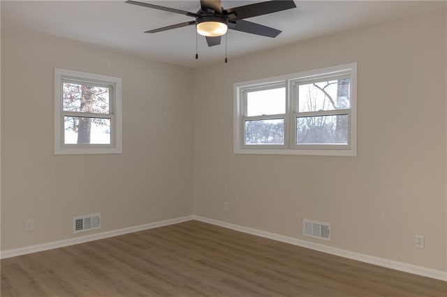 909 Bell Dr, Excelsior Springs, MO 64024 - empty room with wood finished floors, baseboards, and a ceiling fan