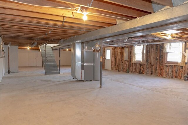 909 Bell Dr, Excelsior Springs, MO 64024 - below grade area with heating unit, stairway, and electric panel