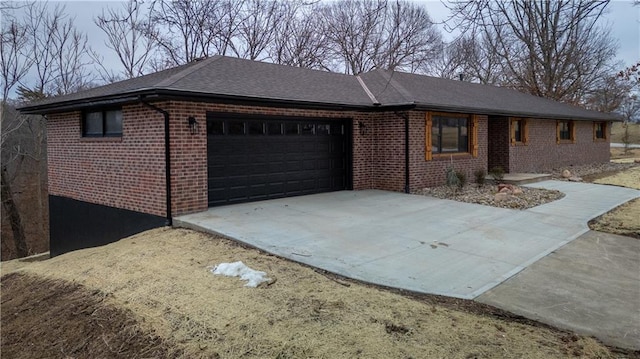 909 Bell Dr, Excelsior Springs, MO 64024 - single story home featuring an attached garage, brick siding, driveway, and a shingled roof