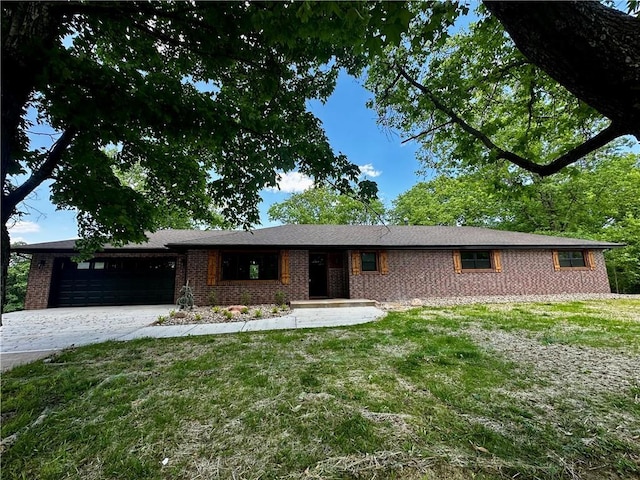 909 Bell Dr, Excelsior Springs, MO 64024 - single story home with a garage, brick siding, a front lawn, and driveway