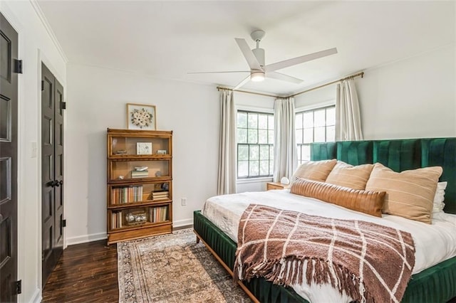 bedroom with baseboards, a ceiling fan, and dark wood finished floors