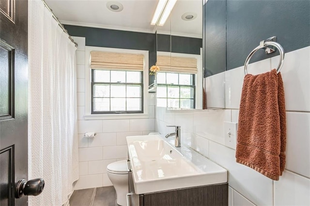 bathroom with a shower with curtain, tile walls, tile patterned floors, vanity, and toilet
