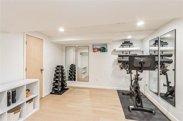workout area with baseboards, recessed lighting, and wood finished floors