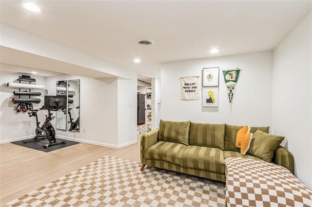 living area with baseboards, recessed lighting, wood finished floors, and visible vents