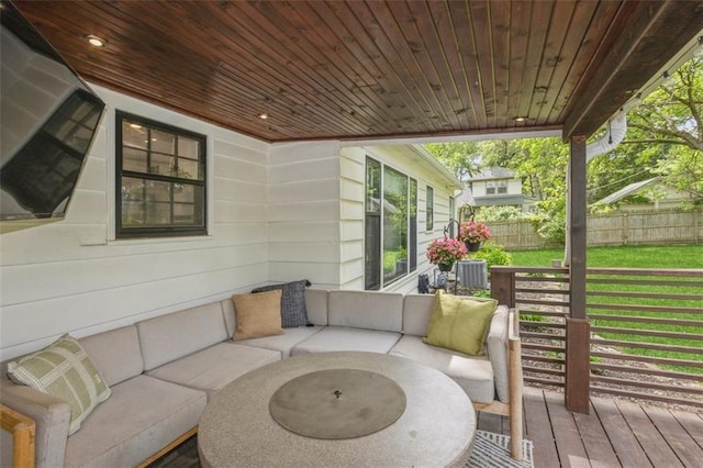 wooden terrace with fence and an outdoor living space
