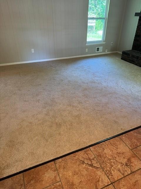 7722 E 90th Ter, Kansas City, MO 64138 - unfurnished living room with carpet floors and baseboards