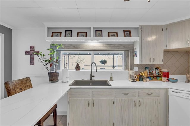 kitchen featuring a sink, light countertops, and white dishwasher
