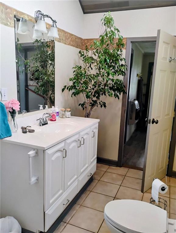 bathroom featuring vanity, tile patterned flooring, and toilet