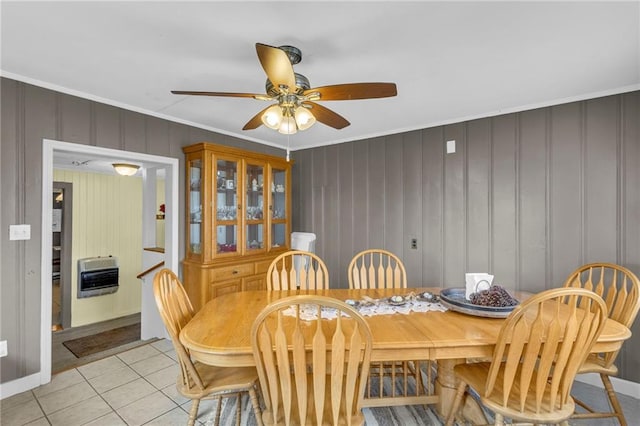 dining area with ornamental molding, heating unit, ceiling fan, and light tile patterned floors