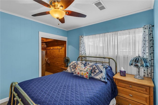 bedroom featuring crown molding, a ceiling fan, and visible vents