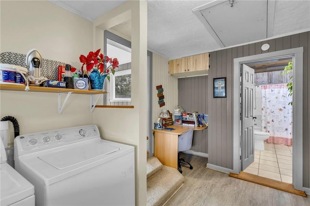 laundry area with laundry area, attic access, light wood-type flooring, baseboards, and separate washer and dryer