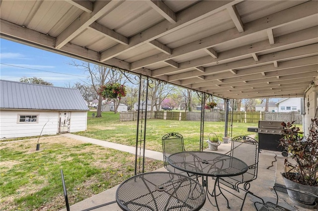 view of patio / terrace featuring fence, outdoor dining space, and a grill