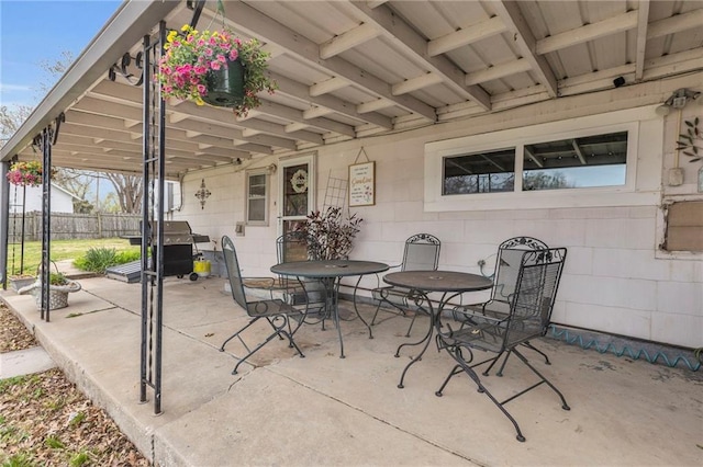 view of patio / terrace featuring fence, grilling area, and outdoor dining space
