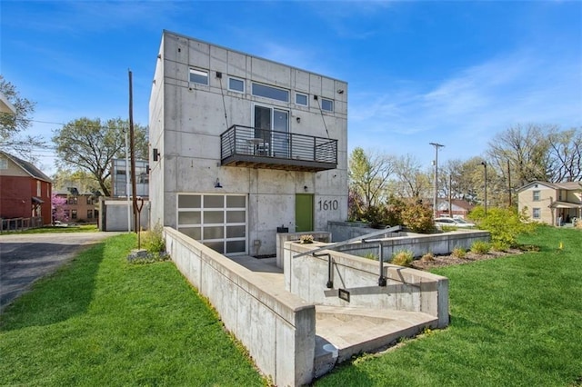 1610 Summit St, Kansas City, MO 64108 - back of property with aphalt driveway, a yard, a balcony, and a garage