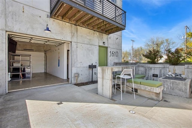 1610 Summit St, Kansas City, MO 64108 - view of patio featuring outdoor dining space and an attached garage