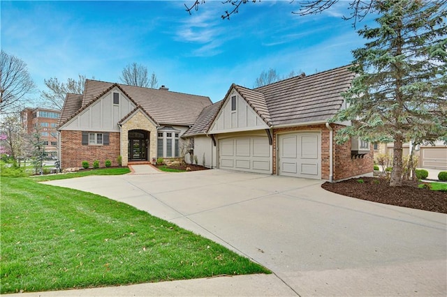view of front of house featuring a front yard, brick siding, concrete driveway, an attached garage, and a tile roof