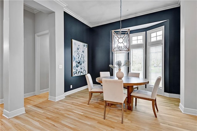 dining room with baseboards, a notable chandelier, ornamental molding, and light wood finished floors