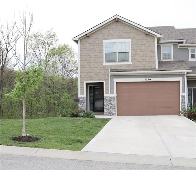 craftsman house featuring concrete driveway, an attached garage, stone siding, and a front lawn