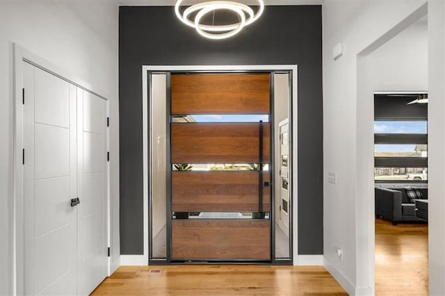 22530 W 87th Ter, Lenexa, KS 66227 - doorway to outside with wood finished floors and a chandelier