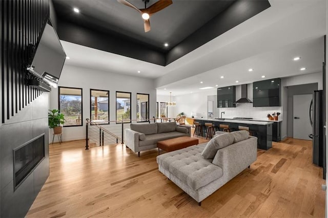 22530 W 87th Ter, Lenexa, KS 66227 - living area with recessed lighting, light wood-style flooring, a chandelier, baseboards, and a high ceiling