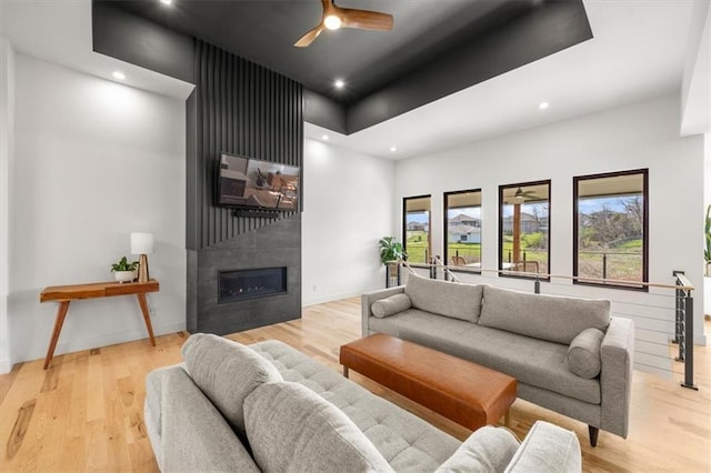 22530 W 87th Ter, Lenexa, KS 66227 - living area featuring recessed lighting, a high ceiling, wood finished floors, a fireplace, and ceiling fan