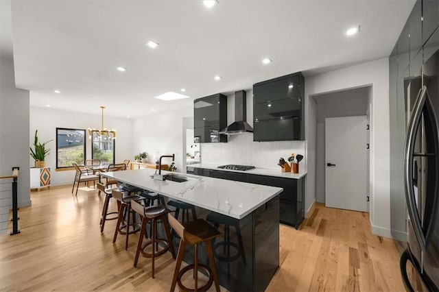 22530 W 87th Ter, Lenexa, KS 66227 - kitchen with wall chimney range hood, black gas stovetop, a sink, modern cabinets, and recessed lighting