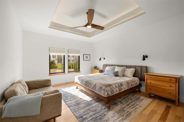 22530 W 87th Ter, Lenexa, KS 66227 - bedroom with a tray ceiling, light wood finished floors, and ceiling fan