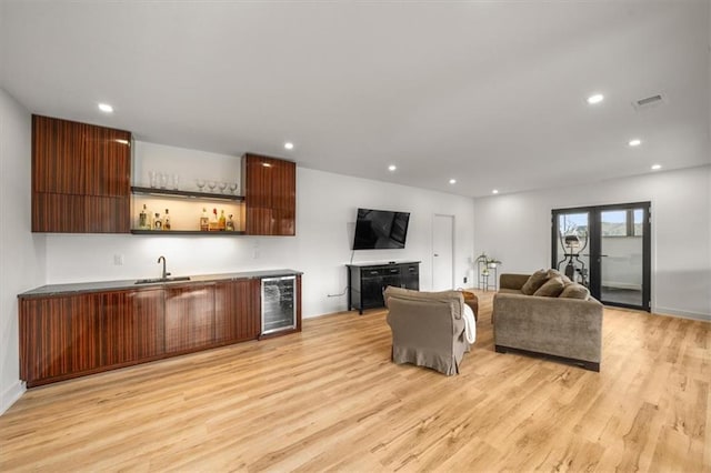 22530 W 87th Ter, Lenexa, KS 66227 - living room featuring wine cooler, bar with sink, light wood-type flooring, recessed lighting, and baseboards