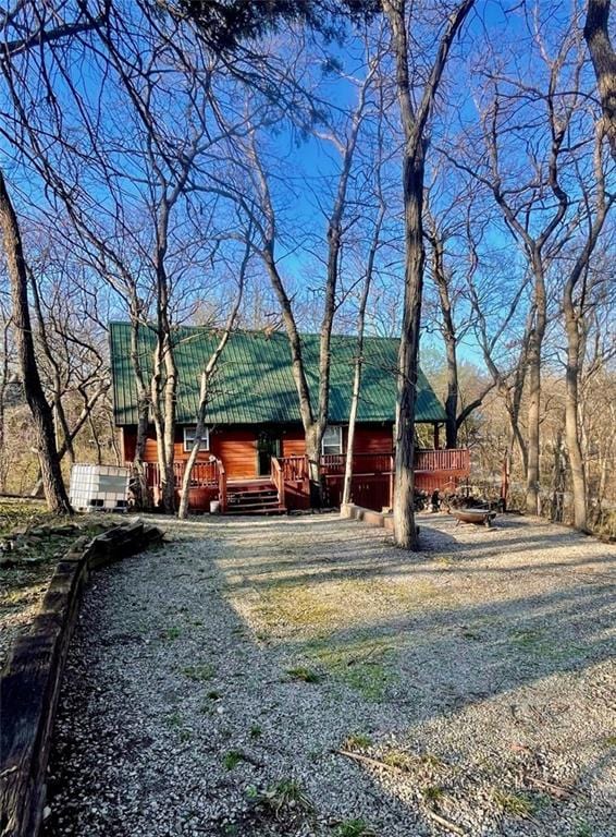518 SW Lakeside Dr, La Cygne, KS 66040 - back of house with metal roof and a wooden deck