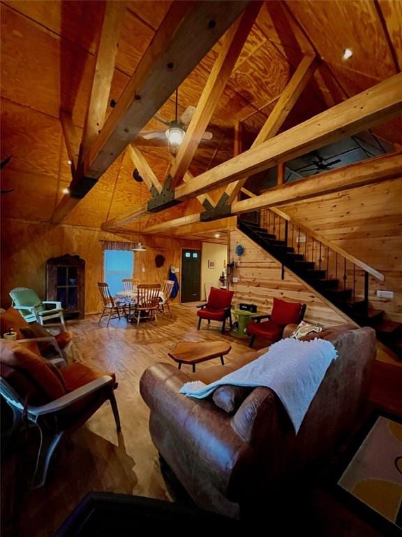 518 SW Lakeside Dr, La Cygne, KS 66040 - living area featuring wood walls, high vaulted ceiling, and stairway