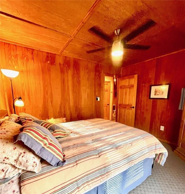 518 SW Lakeside Dr, La Cygne, KS 66040 - bedroom featuring wooden walls, carpet, and ceiling fan