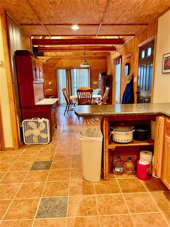 518 SW Lakeside Dr, La Cygne, KS 66040 - interior space featuring wood walls and wooden ceiling