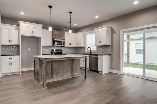 16827 W 164th Ter, Olathe, KS 66062 - kitchen featuring stainless steel appliances, white cabinets, light wood-type flooring, tasteful backsplash, and recessed lighting