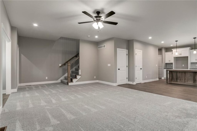 16827 W 164th Ter, Olathe, KS 66062 - unfurnished living room featuring carpet flooring, recessed lighting, a ceiling fan, and stairs