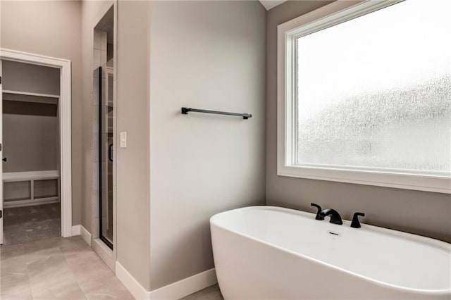 16827 W 164th Ter, Olathe, KS 66062 - full bathroom with a freestanding tub, a spacious closet, and a stall shower