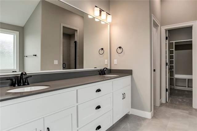 16827 W 164th Ter, Olathe, KS 66062 - bathroom featuring double vanity and a walk in closet