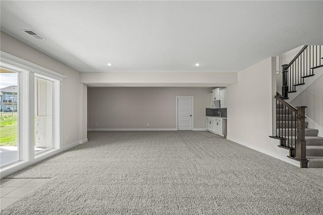 19389 W 114th Ter, Olathe, KS 66061 - unfurnished living room featuring stairs, light carpet, recessed lighting, and baseboards