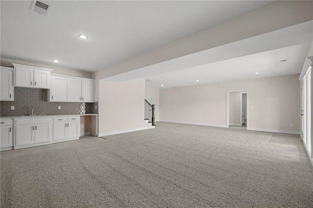 19389 W 114th Ter, Olathe, KS 66061 - kitchen featuring open floor plan, white cabinetry, backsplash, a sink, and recessed lighting