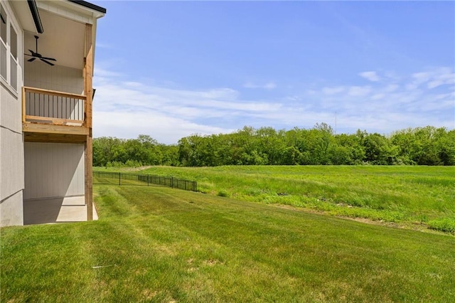 19389 W 114th Ter, Olathe, KS 66061 - view of yard with a ceiling fan, a view of countryside, and a wooded view