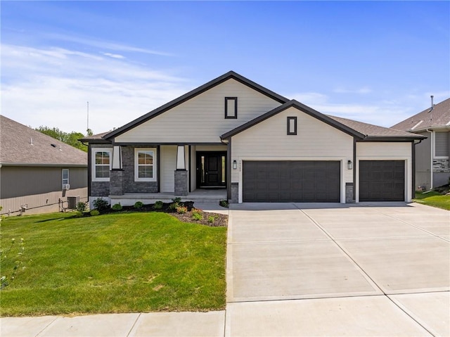 19389 W 114th Ter, Olathe, KS 66061 - view of front facade featuring a garage, concrete driveway, a front lawn, a porch, and stone siding