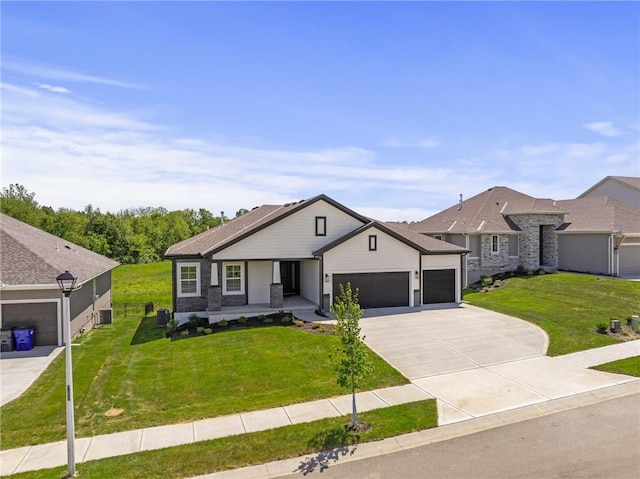 19389 W 114th Ter, Olathe, KS 66061 - view of front of house with an attached garage, a front lawn, driveway, and a porch