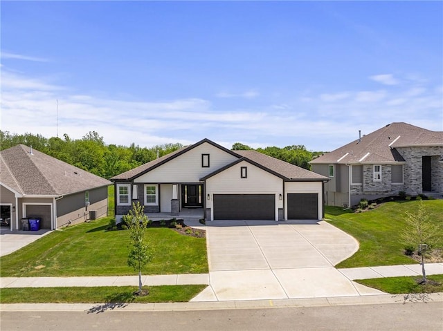 19389 W 114th Ter, Olathe, KS 66061 - view of front of home with a garage, concrete driveway, a front lawn, and covered porch